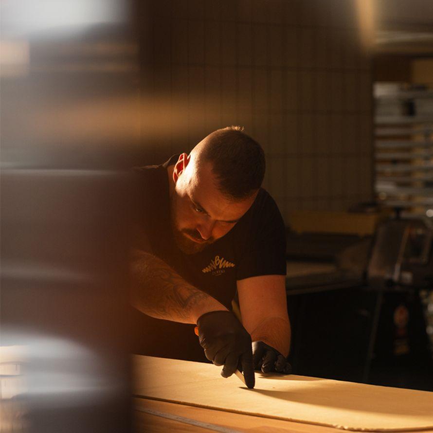 Guy cutting dough